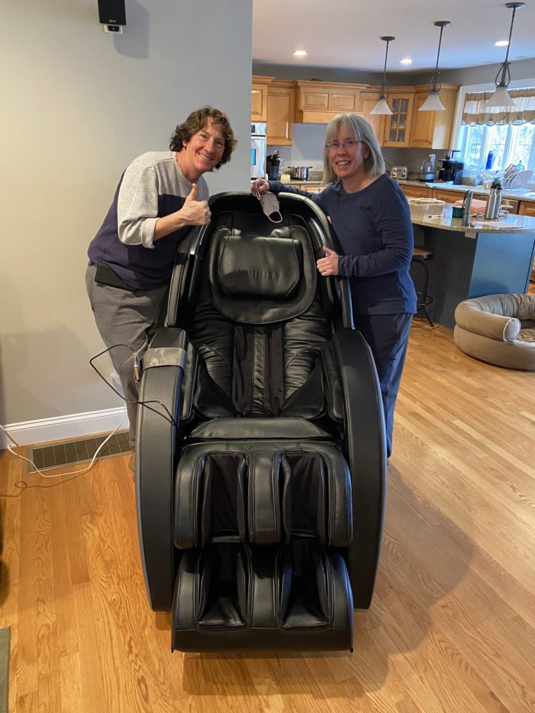 Family enjoying their new full body massage chair from LAIDBACK.