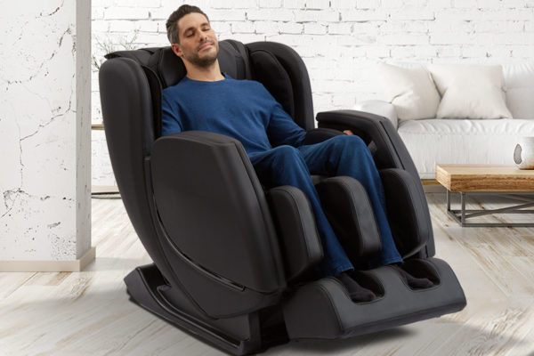 Revival Massage Chair by Sharper Image with man sitting in it