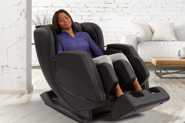 Revival Massage Chair by Sharper Image with woman sitting in it